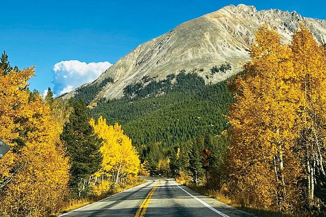 A clear blue lake surrounded by snow-capped mountains in the Canadian Rockies.
